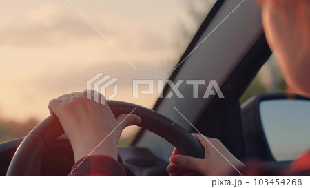 girl driving a car. woman drive a car. concept happy woman car road. The girl is sitting in the front seat of the car. drive the front seat. free woman mother journey. hand steering wheel to press the girl driving a car. woman drive a car. concept happy woman car road. The girl is sitting in the front seat of the car. drive the front seat. free woman mother journey. hand steering wheel to press the 103454268