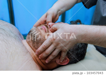 Manual therapist specializes in anti-aging face massages to improve skins elasticity reduce signs of aging. 103457043