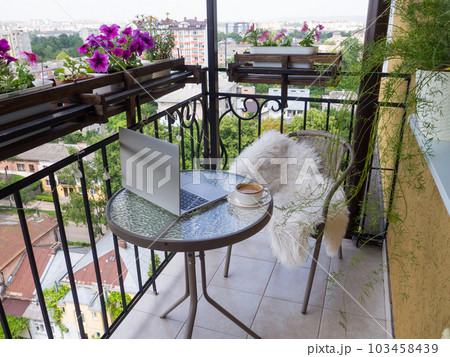cup of cappuccino and flowers view and working at home 103458439