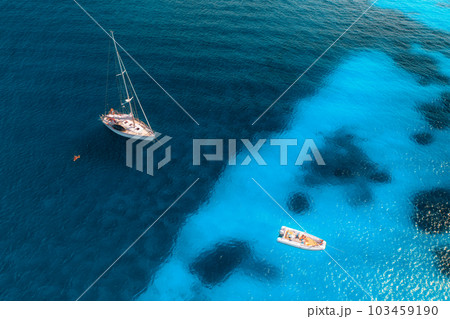 Aerial view of yacht and sail boat on blue sea at sunset 103459190