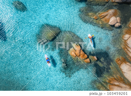 Aerial view of sup boards, blue sea, rocks at sunset in summer 103459201