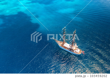 Aerial view of beautiful sailboat in blue sea at sunset in summer 103459202