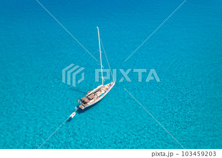 Aerial view of beautiful sailboat in blue sea at sunset in summer 103459203