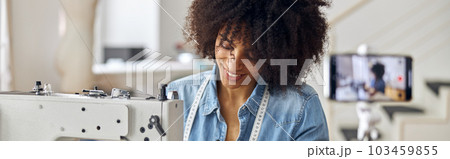 African-American seamstress sews clothes shooting video for blog African-American seamstress sews clothes shooting video for blog 103459855