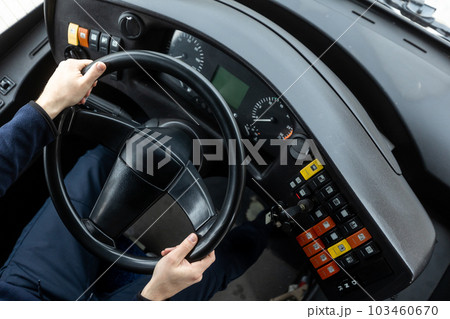 Cockpit or cabin of public transport, bus driver holding steering wheel, concept of urban public transportation 103460670