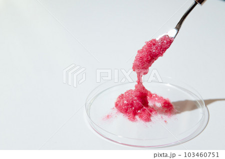 Natural Scrub with Heating Effect in Laboratory Petri Dish with metal Spatula for testing Sample on white background 103460751