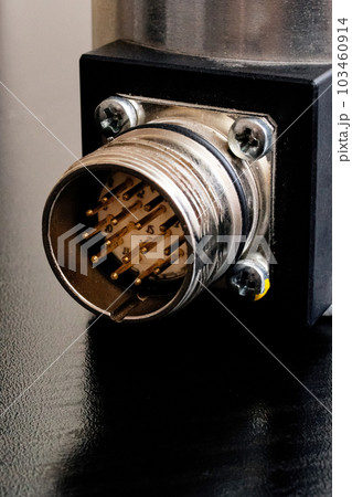 Metal encoder on a black wooden table 103460914