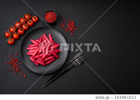 Delicious penne pasta with beets, cheese, salt and spices 103461012