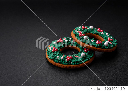 Delicious Christmas gingerbread on a dark textural background Delicious Christmas gingerbread on a dark textural background 103461130