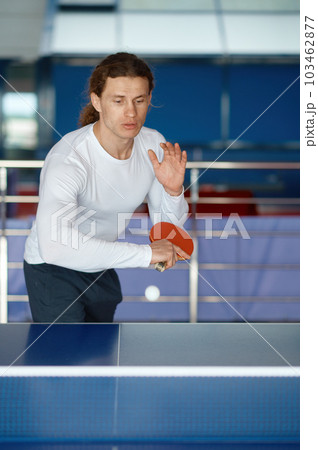 Portrait of happy male athlete playing table tennis at training sport club Portrait of happy male athlete playing table tennis at training sport club 103462877
