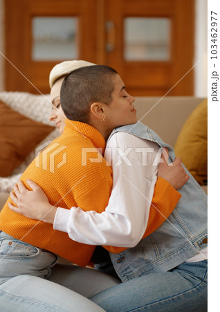 Young lesbian woman couple supporting each other, reconciling after quarrel 103462977