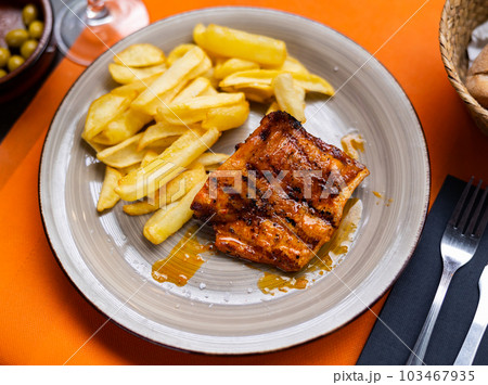 Appetizing fried pork with potatoes and spices on table 103467935
