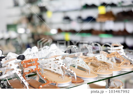 Fashionable summer women shoes on the shelves of shoe store 103467992