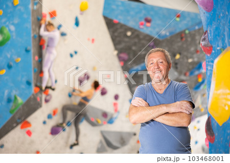 Adult man posing on climbing wall 103468001