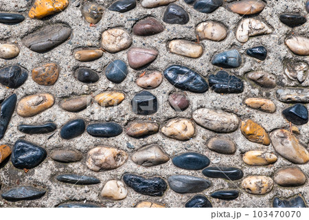 Multicolor stones decoration on concrete top close-up view in Chengdu, Sichuan province, China Multicolor stones decoration on concrete top close-up view in Chengdu, Sichuan province, China 103470070
