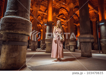 Woman tourist enjoying Beautiful cistern in Istanbul. Cistern - underground water reservoir build in 6th century, Istanbul, Turkey, Turkiye Woman tourist enjoying Beautiful cistern in Istanbul. Cistern - underground water reservoir build in 6th century, Istanbul, Turkey, Turkiye 103470635