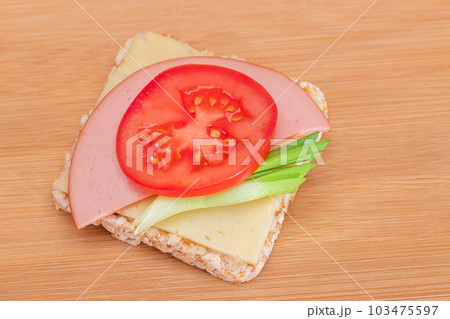 Rice Cake Sandwich with Tomato, Sausage, Green Onions and Cheese 103475597