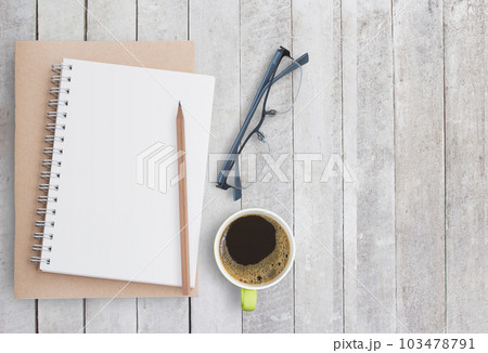 Blank paper notebook on white wood background. 103478791
