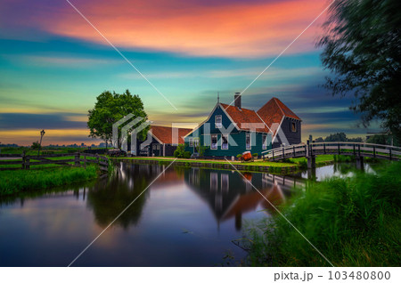 Sunset above historic farm houses in the holland village of Zaanse Schans 103480800