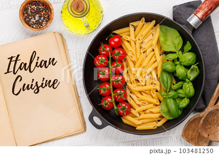 A vibrant representation of the Italian flag made with pasta, basil, and tomatoes 103481250