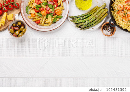Italian pasta adorned with fresh tomatoes and aromatic basil 103481392