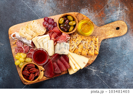 Antipasto board with prosciutto, salami, crackers, cheese 103481403