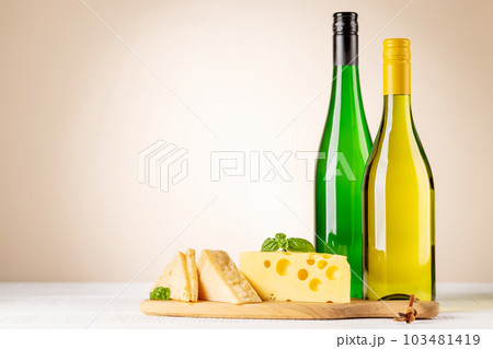 Various cheese on board and white wine Various cheese on board and white wine 103481419