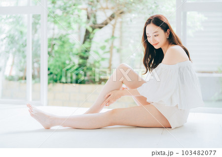 脚のスキンケアとマッサージをする若い女性 103482077