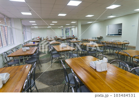 Chairs and tables. The dining hall in school is quarantined, isolation. 103484531