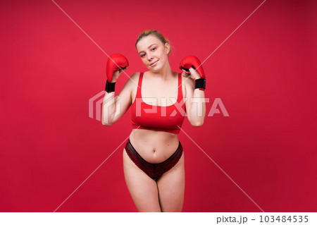 Boxer, seductive confident female boxer with gloves studio, sporty woman posing looking at camera. 103484535