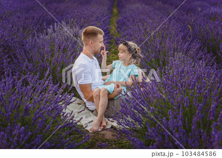 father and daughter are playing in a lavender field father and daughter are playing in a lavender field 103484586