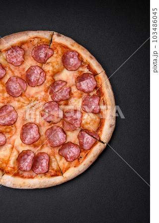 Tasty fresh pizza with salami, cheese, tomatoes, spices and salt 103486045