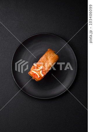 Round puff pastry croissant with citrus filling or New York roll 103486099