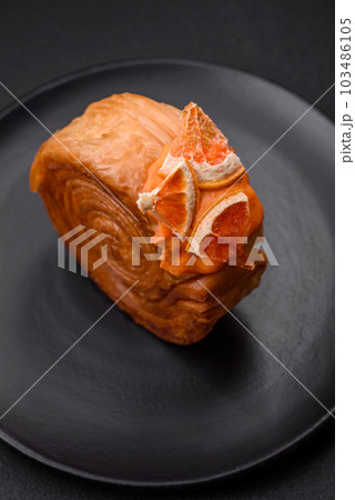Round puff pastry croissant with citrus filling or New York roll 103486105