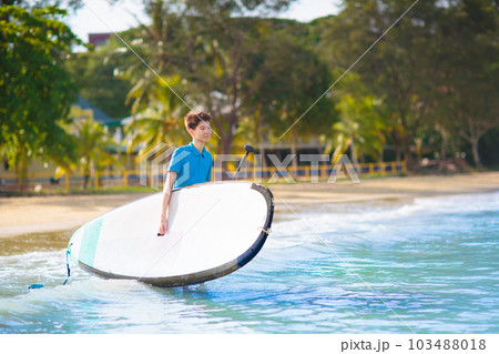 Child on stand up paddle. Water and beach sport 103488018