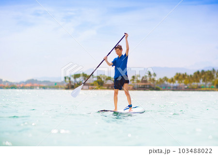 Child on stand up paddle. Water and beach sport 103488022