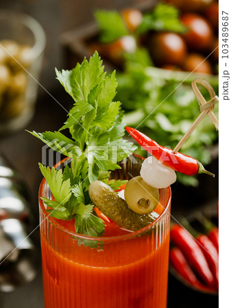 Close up bloody mary cocktail with celery,pickle,olive and red pepper Close up bloody mary cocktail with celery,pickle,olive and red pepper 103489687