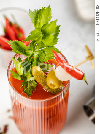 Close up bloody mary cocktail with celery,pickle,olive and red pepper Close up bloody mary cocktail with celery,pickle,olive and red pepper 103489688