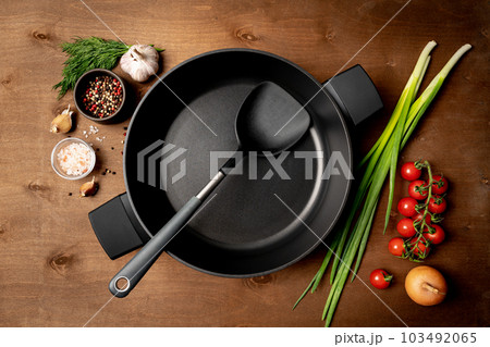 Empty pan surrounded by vegetarian 103492065