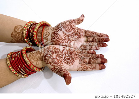 Beautiful Indian female hands with henna tattoo isolated on white background 103492527