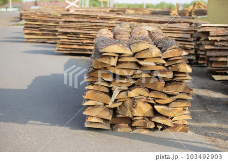 The territory of the woodworking plant. Folded boards with wood 103492903