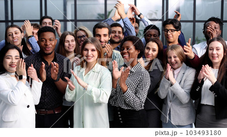 Group of young businesswomen smiling happy and clapping. Standing and looking to the camera at the office. Group of young businesswomen smiling happy and clapping. Standing and looking to the camera at the office. 103493180