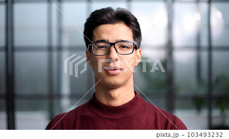 Handsome young Asian man smiling in a red sweatshirt 103493232