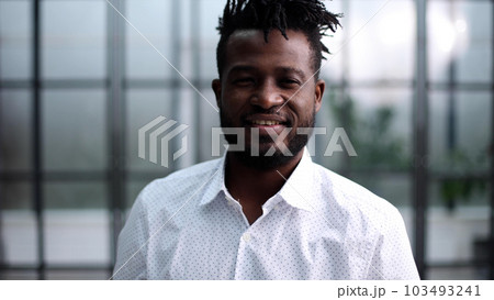 Confident young smiling businessman in shirt posing at camera Confident young smiling businessman in shirt posing at camera 103493241