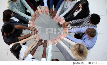 Friends with stack of hands showing unity and teamwork. Friends with stack of hands showing unity and teamwork. 103493396