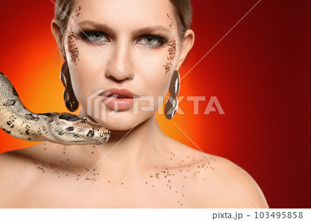 Beautiful woman with boa constrictor on bright colorful background, closeup 103495858