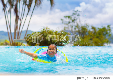Child in swimming pool on toy ring. Kids swim. Child in swimming pool on toy ring. Kids swim. 103495960