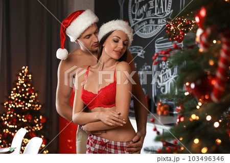 Passionate young couple enjoying each other at home. Christmas celebration 103496346