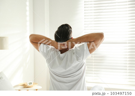 Man awakening on bed at home. Lazy morning 103497150