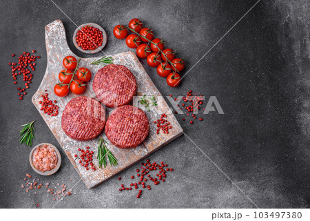 Fresh raw ground beef burger patty with salt and spices Fresh raw ground beef burger patty with salt and spices 103497380